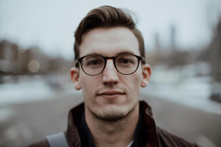 Young man wearing glasses outside